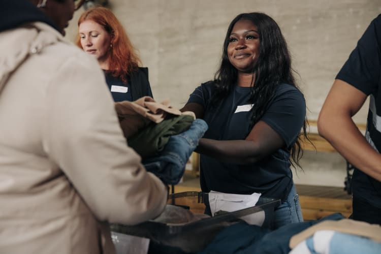 Volunteer handing out clothes
